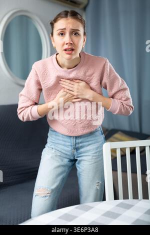 Young woman suffering from chest pain Stock Photo