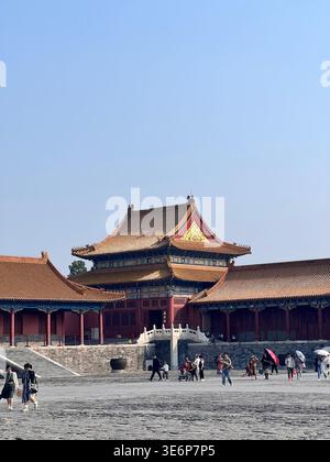 Visitors in a palace courtyard inside the Forbidden City in Beijing, China. Stock Photo
