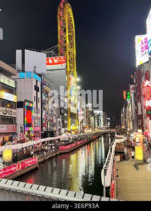 Night view of the Dotonbori canal and ferris wheel in Osaka, Japan. Stock Photo