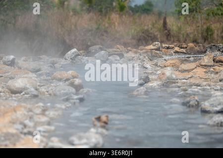 Steaming clean mineral water in natural hot springs pond at Mueang Paeng province in Thailand. Stock Photo