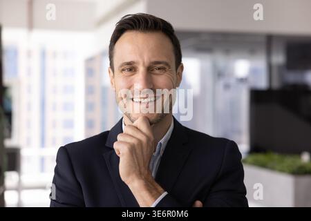 Headshot portrait happy successful businessman looking at camera with smile Stock Photo