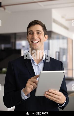 Young smiling male executive holding tablet device Stock Photo