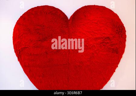 a decorative red heart-shaped plush pillow often used for home decor or as a gift Stock Photo