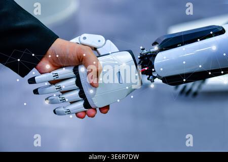 Robot and human handshake representing artificial intelligence collaboration and future technology. Stock Photo
