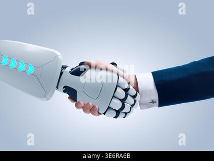 Handshake between a human businessman and a futuristic robot. Concept of AI collaboration, human-robot partnership, and future business technology. Stock Photo