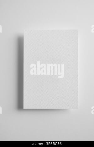 Textured blank paper mockup with soft shadow minimal gray background clean layout template vertical copy space Stock Photo