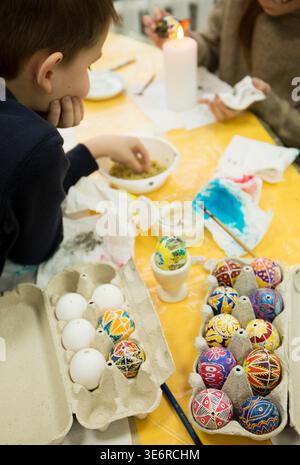 Children learn to paint Easter eggs using wax according to the ancient Ukrainian tradition Stock Photo