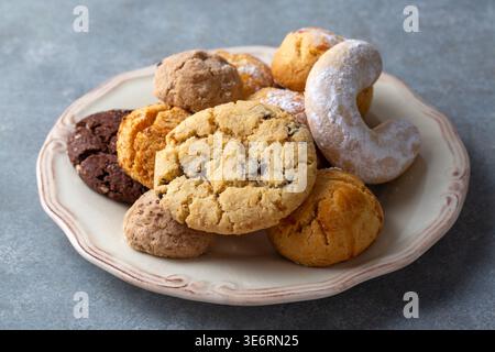 Assorted Sweet Turkish Cookies and Pastries with Chocolate Chips and Powdered Sugar on a Plate Stock Photo