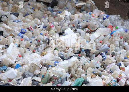 plastic and metal waste material in the water canal Stock Photo