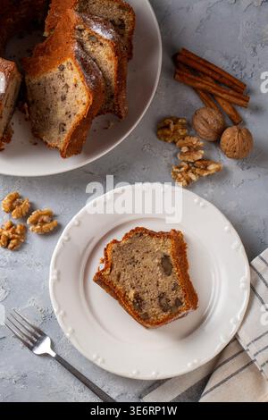 Homemade Sliced Bundt Cake with Walnuts and Cinnamon Sprinkled with Powdered Sugar Stock Photo