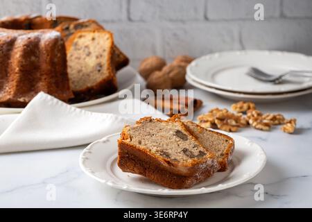 Homemade Sliced Bundt Cake with Walnuts and Cinnamon Sprinkled with Powdered Sugar Stock Photo