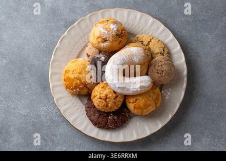 Assorted Sweet and Savory Turkish Cookies with Cocoa Powdered Sugar and Sesame Seeds on a Plate Stock Photo