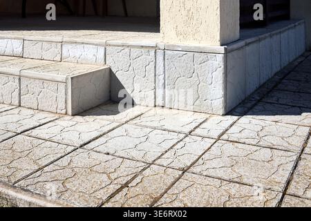 Close up shot of decorative grey cement concrete slab with porch and step. Cement concrete in rectangular pattern for garden footpath outdoor. Stock Photo
