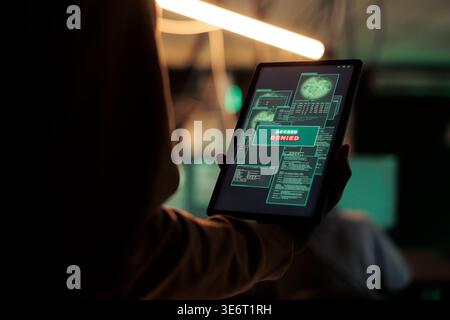 Access denied message on digital tablet screen, unsuccessful password cracking, database hacking fail. Cyberattack, internet thief stealing electronic information, using malicious software Stock Photo