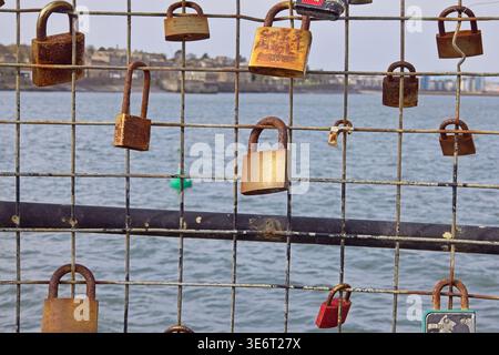 Padlocks symbolising love on pier fence at Newhaven Harbour, Edinburgh, Scotland Stock Photo