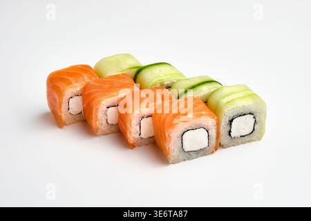 Six Philadelphia sushi rolls, three wrapped in fresh salmon and three wrapped in cucumber, with cream cheese filling, isolated on white background. Ja Stock Photo