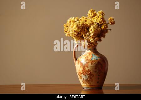 dried flowers in a vase on the table Stock Photo