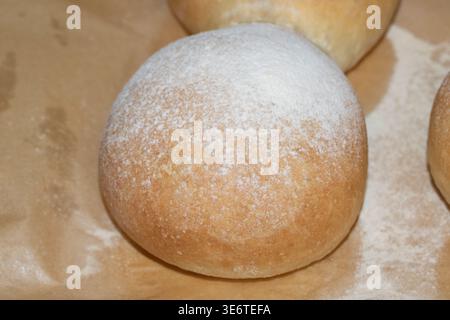 Home made bread roll baps freshly cooked with flour sprinkled on top Stock Photo