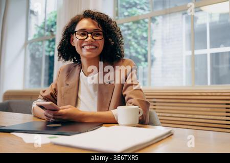 Energized Female Business Owner Working On Innovative Projects Within Lively Workspace Environment Stock Photo