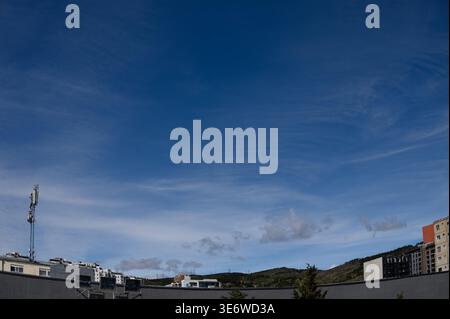High-resolution photo of a dramatic cloudscape with cirrus and cumulus clouds, showing a vibrant blue sky layered with wispy cirrus clouds above and s Stock Photo