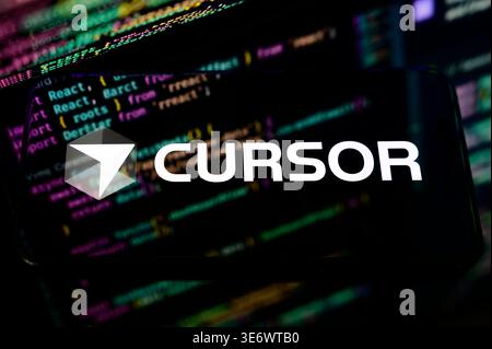 Paris, France - April 1, 2026: The logo of Cursor, an AI-powered code editor, displayed on a smartphone screen with source code background. Stock Photo
