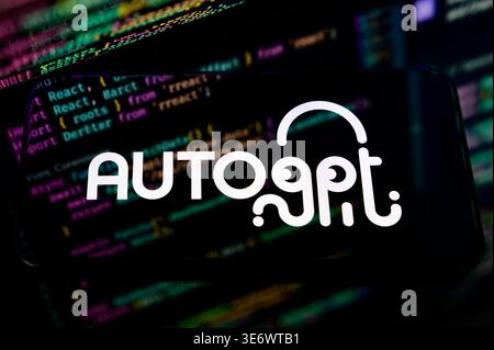 Paris, France - April 1, 2026: The AutoGPT logo shown on a mobile device over a backdrop of programming code, representing autonomous AI agents. Stock Photo