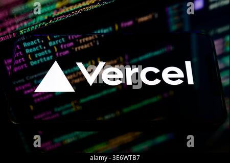 Paris, France - April 1, 2026: The Vercel logo displayed on a mobile screen over lines of code, illustrating cloud hosting and frontend deployment. Stock Photo