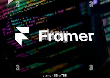 Paris, France - April 1, 2026: A smartphone displays the Framer logo against a programming code background, highlighting AI-driven web design tools. Stock Photo
