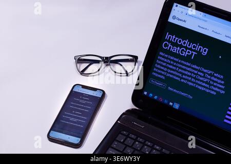 laptop and phone with open chat GPT pages, Ukraine-March 12, 2023, workplace, copy space. Stock Photo