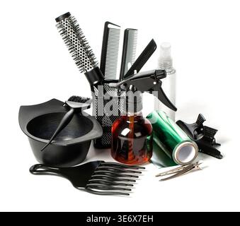Hairdressing tools for salon professionals including combs, brushes, and spray bottles on white background Stock Photo