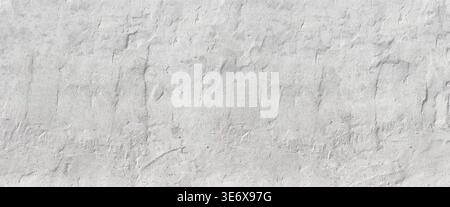 White textured plaster wall providing a rustic and abstract background Stock Photo
