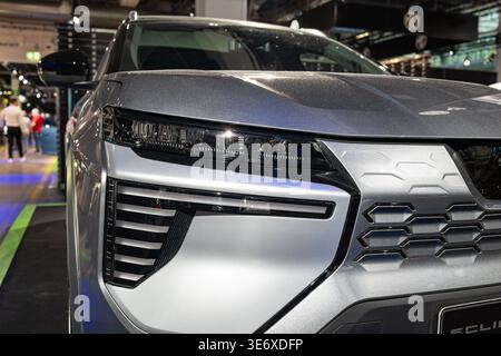 Zurich, Switzerland, October 10, 2025. Detailed front angle close up of the silver Mitsubishi Eclipse Cross LED headlight and grille at the Zurich Aut Stock Photo