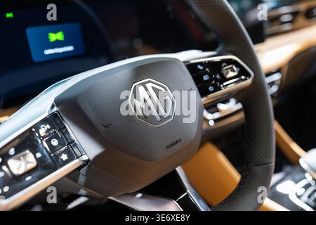 Zurich, Switzerland, October 10, 2025. Close-up of the multi-function steering wheel and logo inside a red MG HS at the Zurich Auto Show Stock Photo