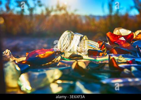 Broken Glass Jars and Shards Colorful Close Up at Golden Hour in Desert Ghost Town Stock Photo