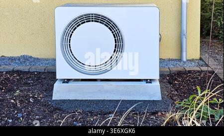Close-up of white heat pump unit installed outdoors Stock Photo