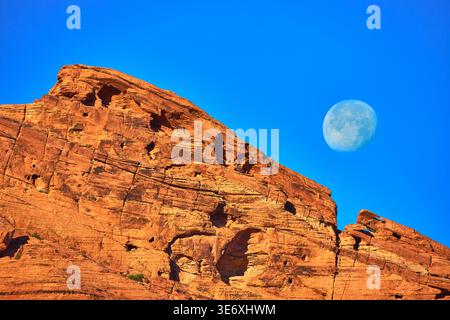 Red Sandstone Formation with Moon in Blue Sky Nevada Desert Landscape Stock Photo