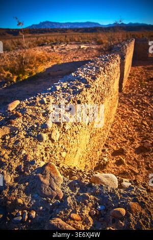 Old Stone Wall Ruin in Desert Ghost Town Nevada Mountains in Distance Stock Photo