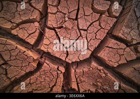 Desert Mud Crack Texture at Golden Hour in Arid Landscape Stock Photo
