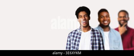 Afro Teenage Guy Poses With Hands in Pockets in Front of White Background With Friends Stock Photo