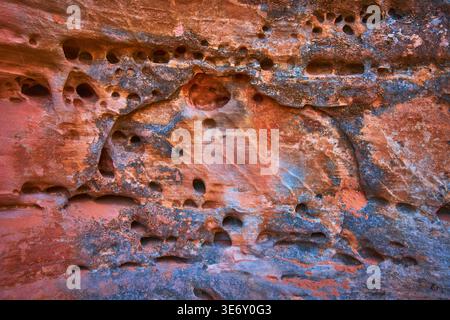 Textured Sandstone Wall With Erosion Holes And Mineral Stains Close Up Stock Photo