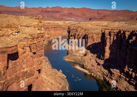 Colorado River flowing through Marble Canyon seen from Navajo Bridge, Arizona Utah border with towering red rock cliffs Stock Photo