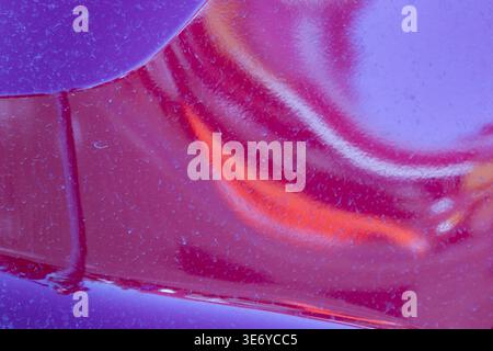 View of abstract patterns in purple and red hues create a mesmerizing dance of light and shadow, Dronten, Flevoland, Netherlands. Stock Photo