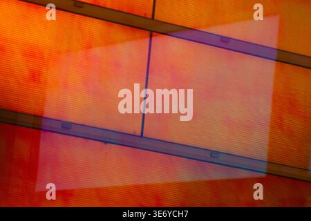 View of geometric abstraction featuring orange and red hues overlaid with a translucent rectangular form, creating depth and visual intrigue, La Defen Stock Photo