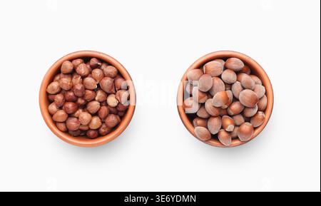 Peeled and unpeeled hazelnuts in ceramic bowls Stock Photo