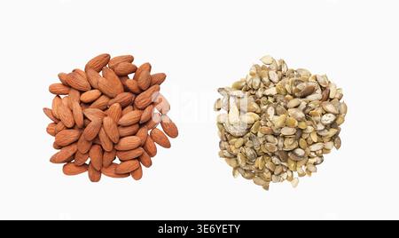 Pumpkin seeds and almonds in separate heaps Stock Photo