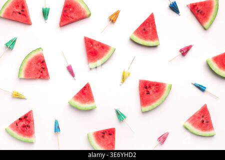 Fresh watermelon slices and colorful paper cocktail umbrellas Stock Photo