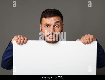 Disappointed businessman showing blank white empty paper Stock Photo