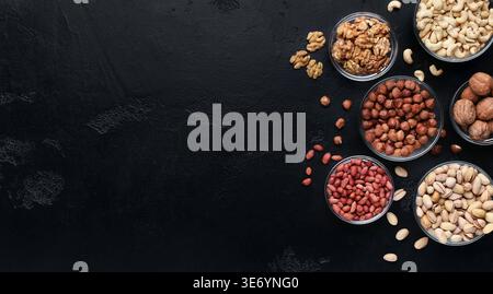 Various nuts in glass bowls on black background Stock Photo