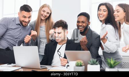 Happy business team celebrating completion of project Stock Photo