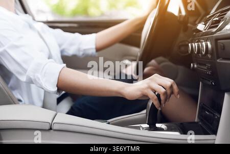 Business woman driver shifting automatic transmission and driving Stock Photo